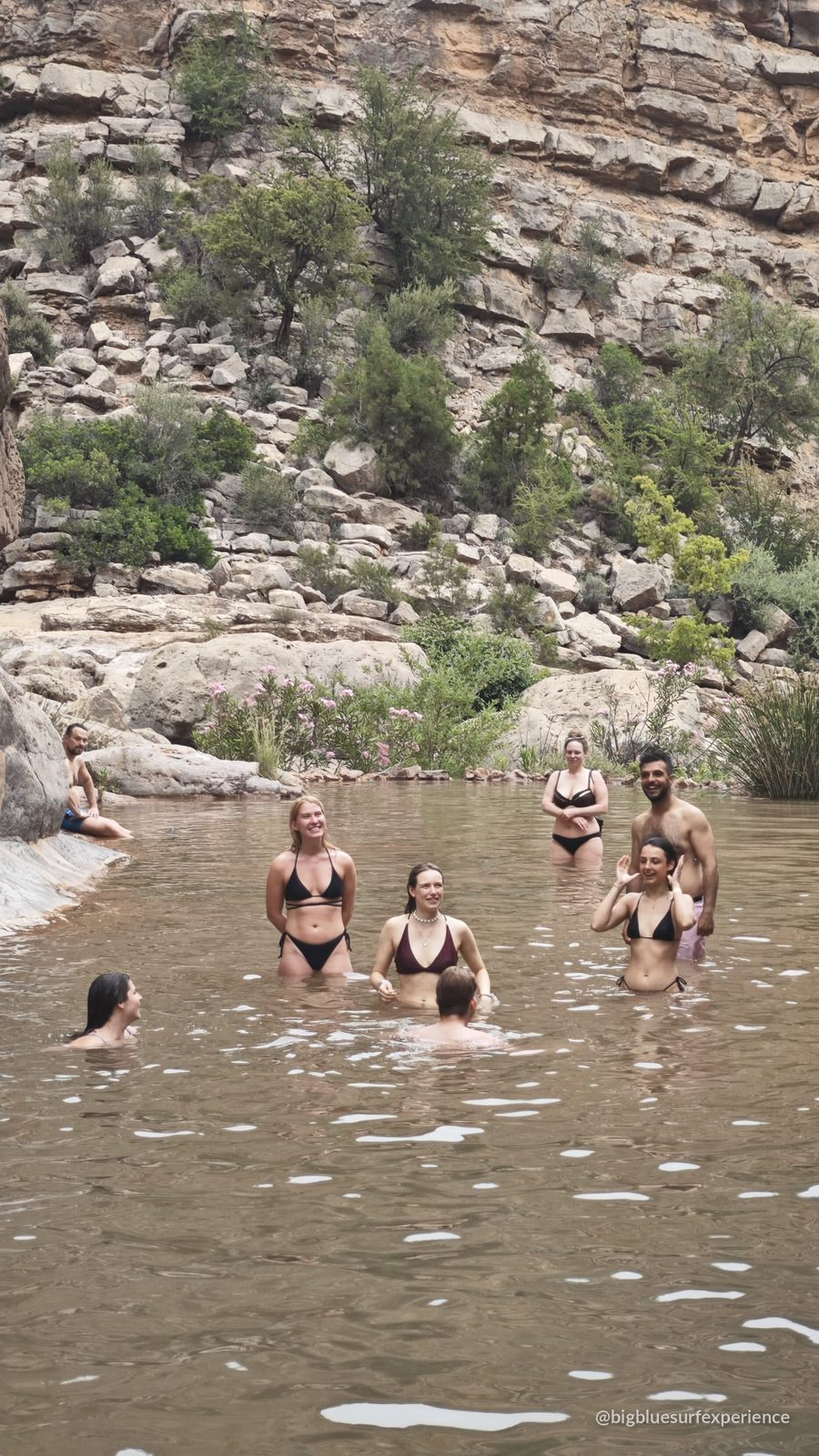 Guests swimming in the turquoise canyon pools of Paradise Valley near Taghazout